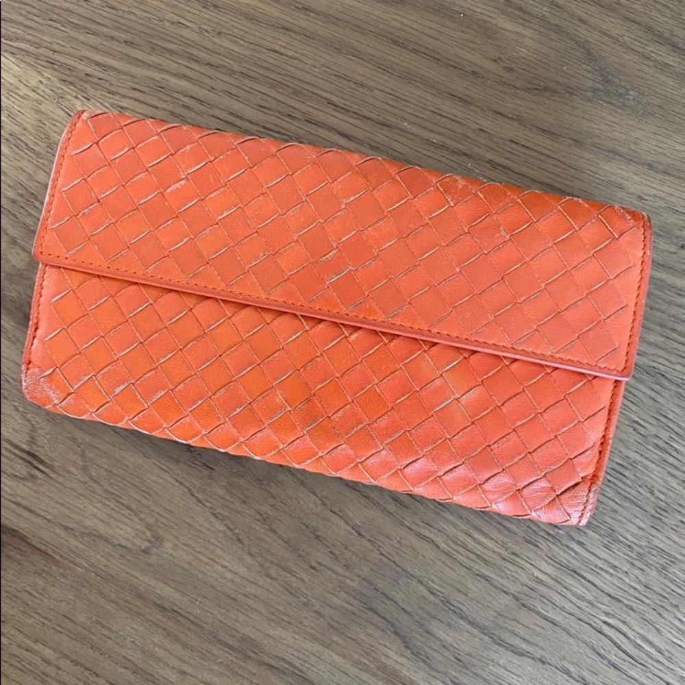 Bottega Veneta Orange woven leather wallet.